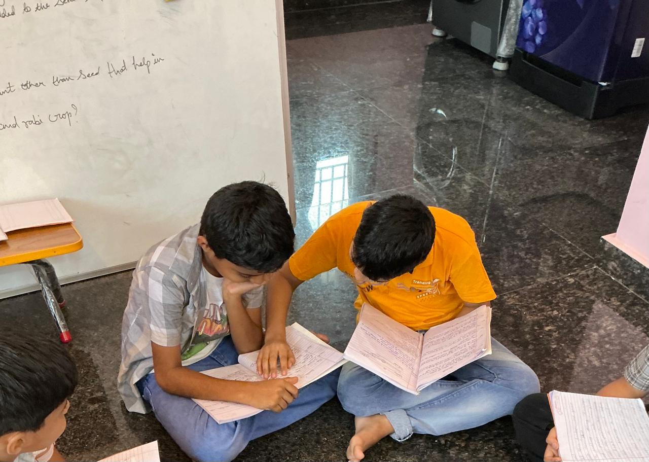Senior students mentoring juniors at Divya Classes in library setting